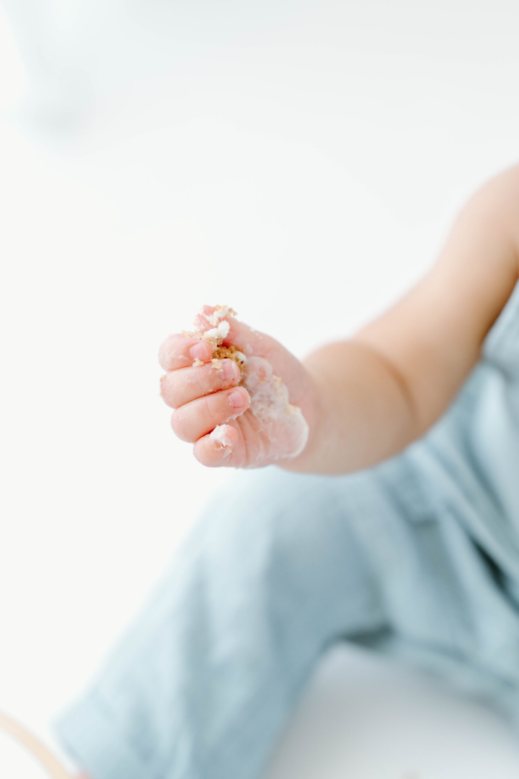 Close-up of Zachary's hand full of cake