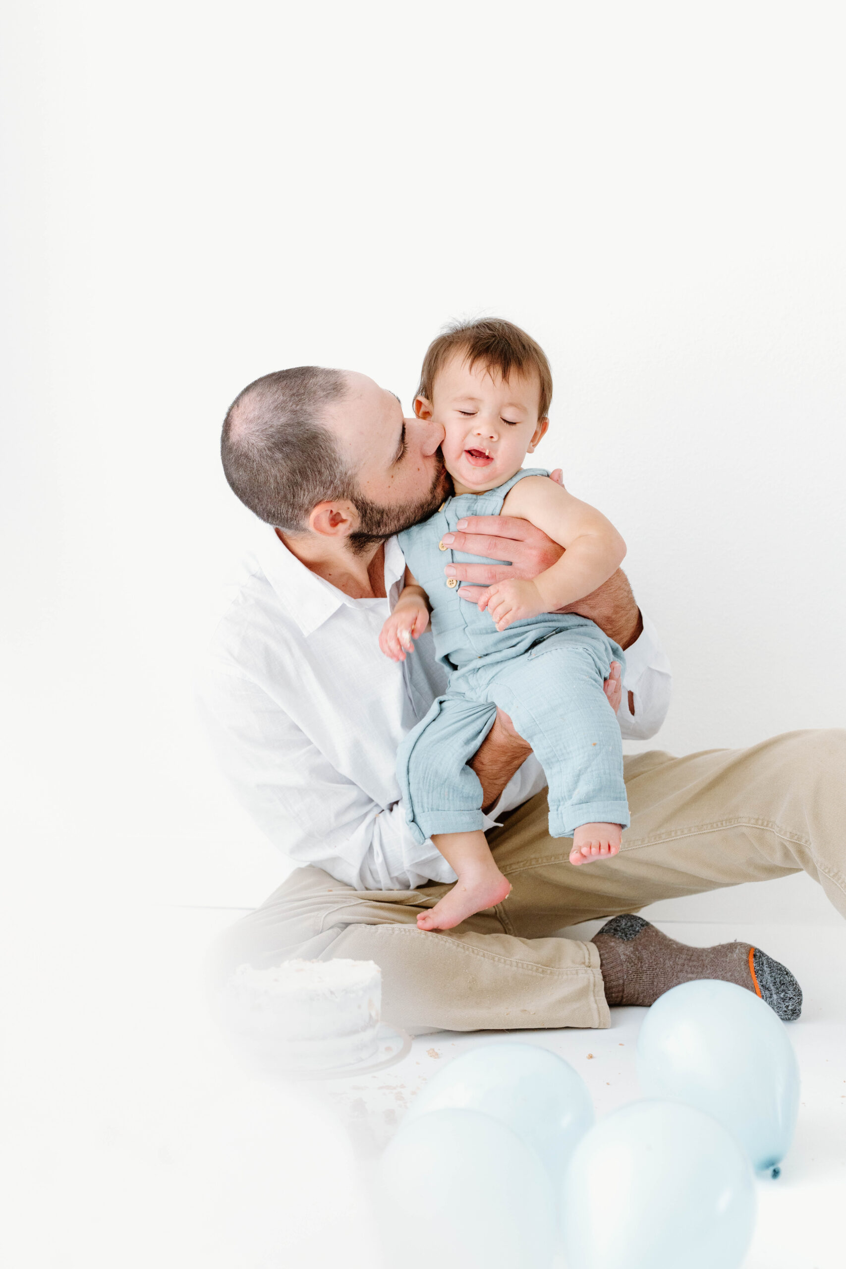 Zachary's dad kisses him as he holds him