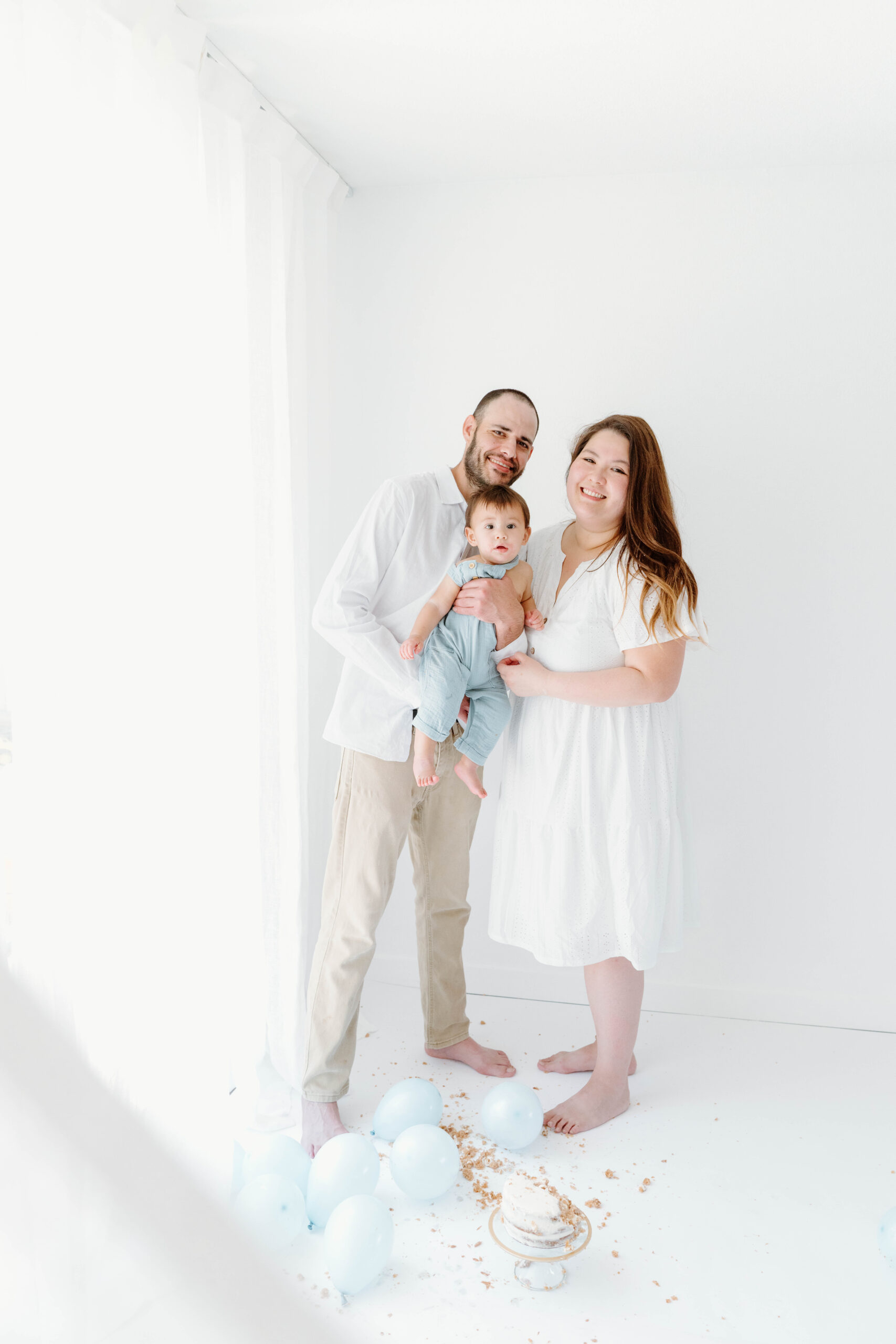 Zachary with his mom and dad in the white studio