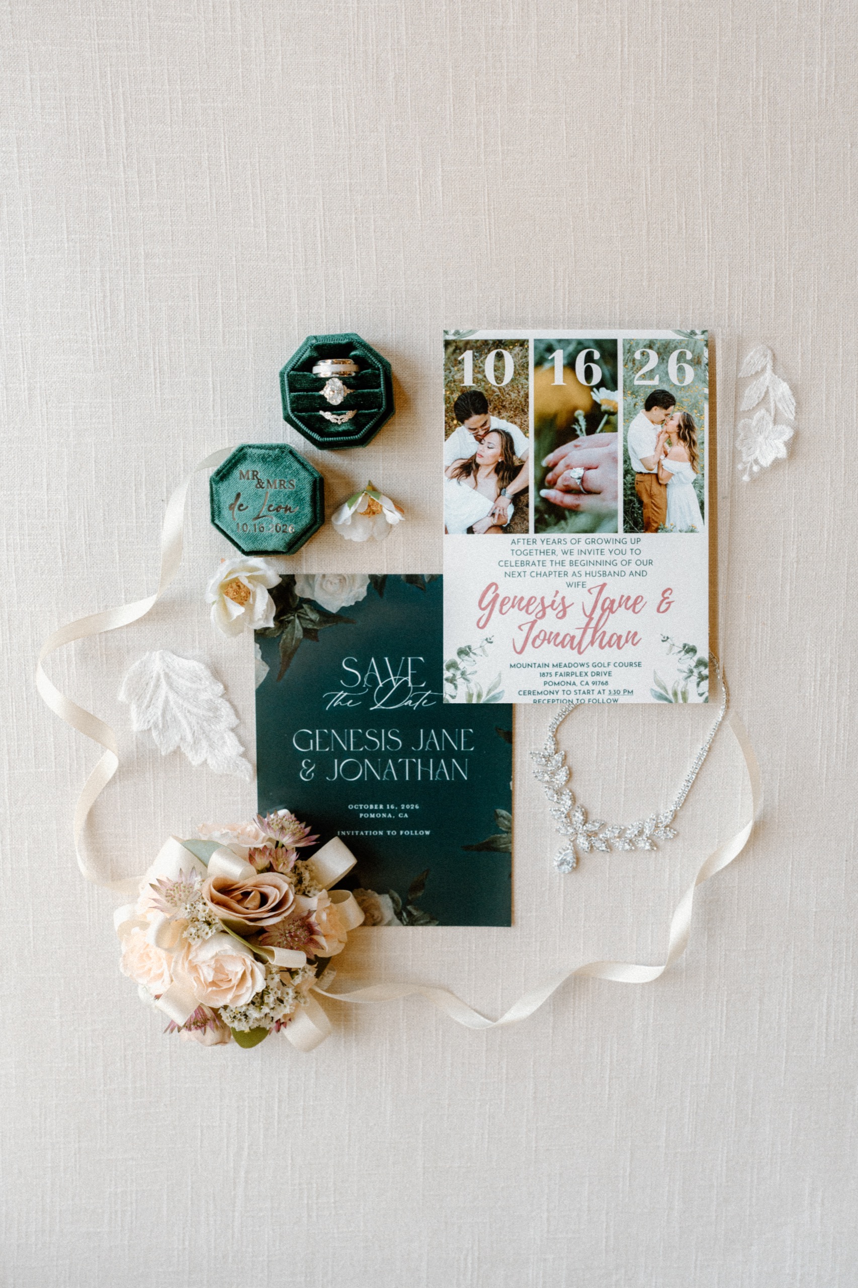 Wedding invitation suite, ring boxes, and details laid out before Jane and Jon’s wedding at Mountain Meadows Golf Course