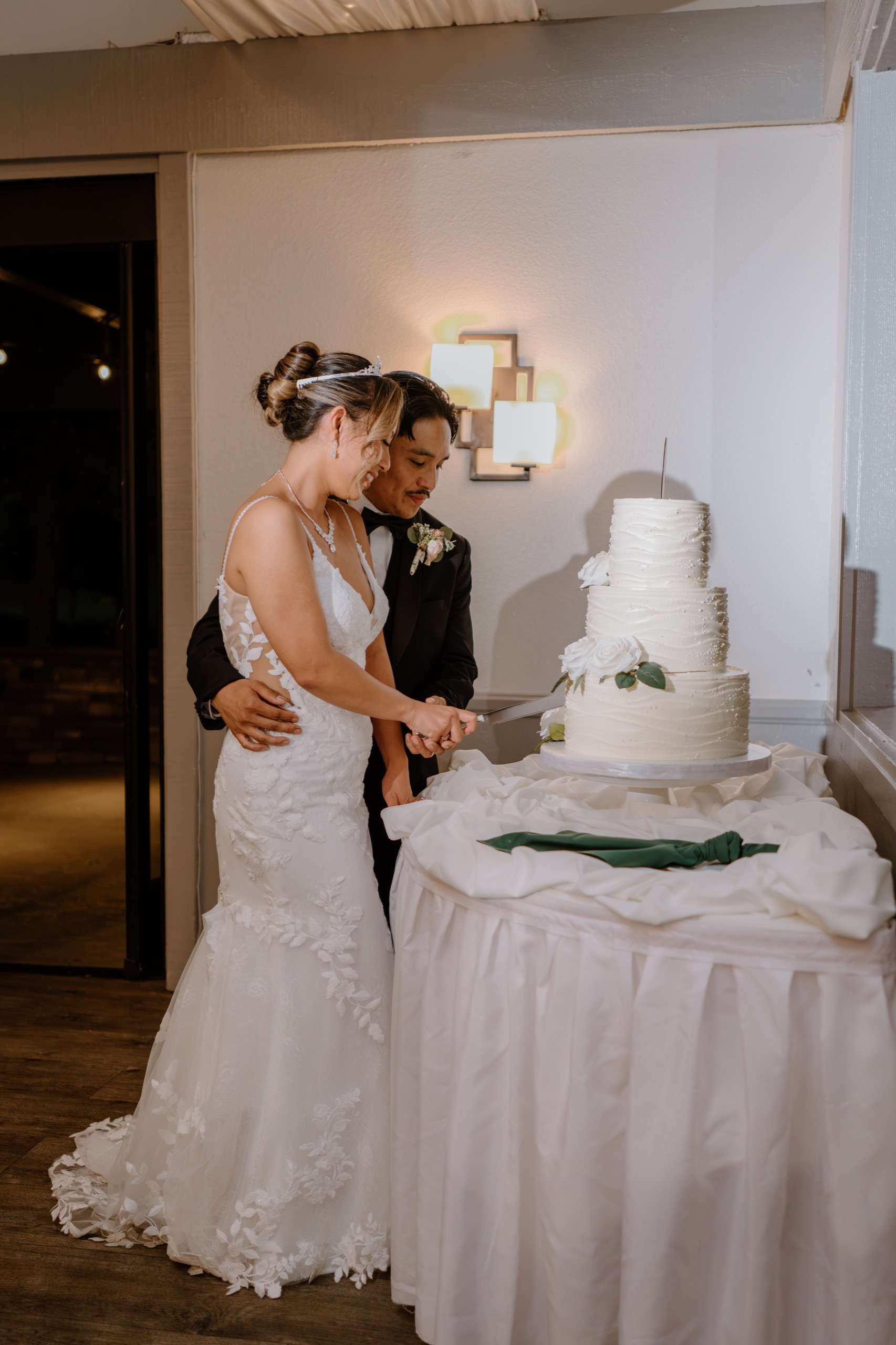 Bride and groom cutting their wedding cake together