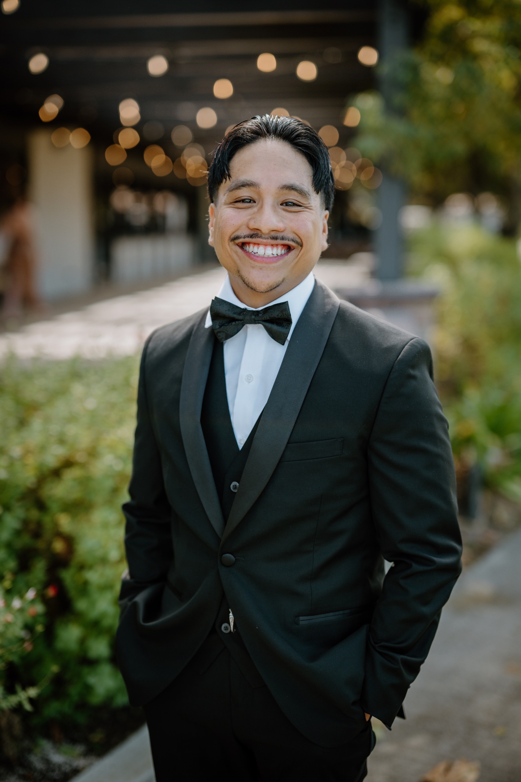 Jon grinning in his black tuxedo and bow tie