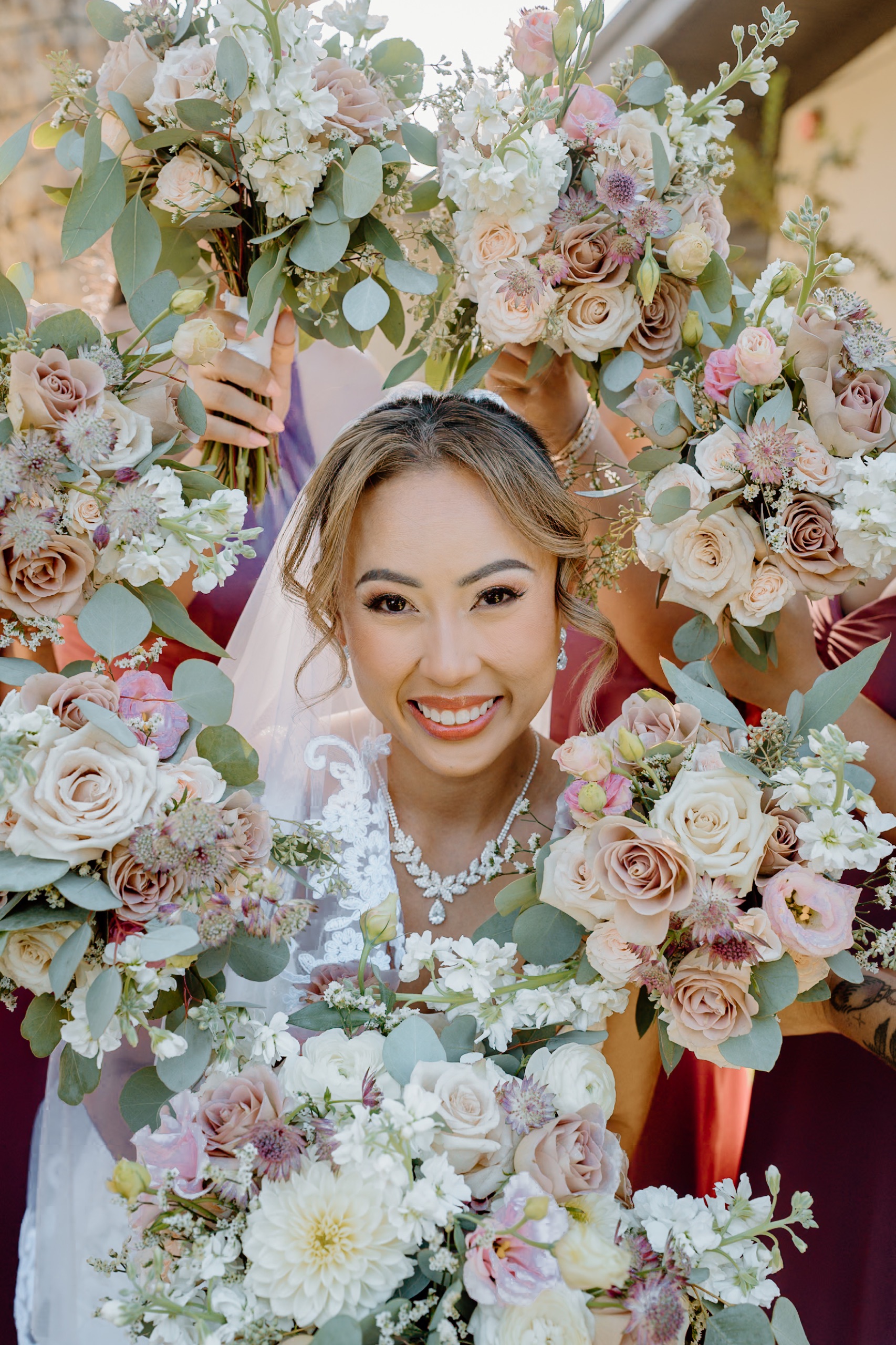 Jane framed by her bridesmaids’ bouquets